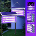 Solar-powered mosquito light with purple glow in a garden setting